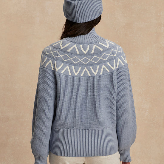 blue ribbed jumper with white varley logo and high neck rear view