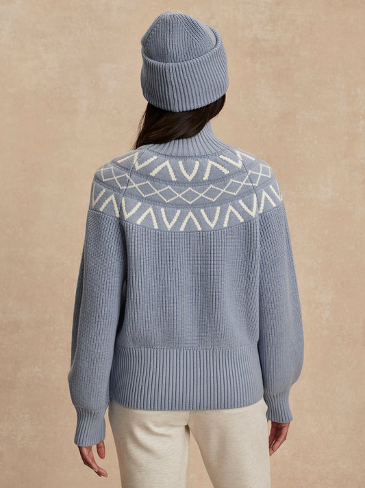 blue ribbed jumper with white varley logo and high neck rear view