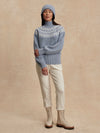blue ribbed jumper with white varley logo and high neck model shot