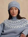 blue ribbed jumper with white varley logo and high neck close up