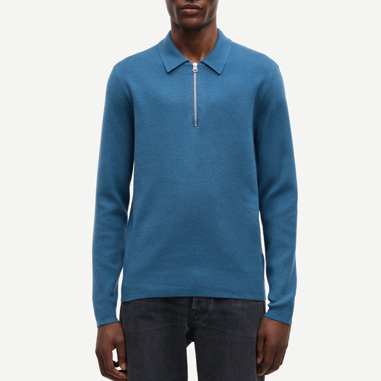 Blue long-sleeve polo shirt with a half zipped placket and relaxed fit model shot