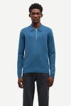 Blue long-sleeve polo shirt with a half zipped placket and relaxed fit model shot