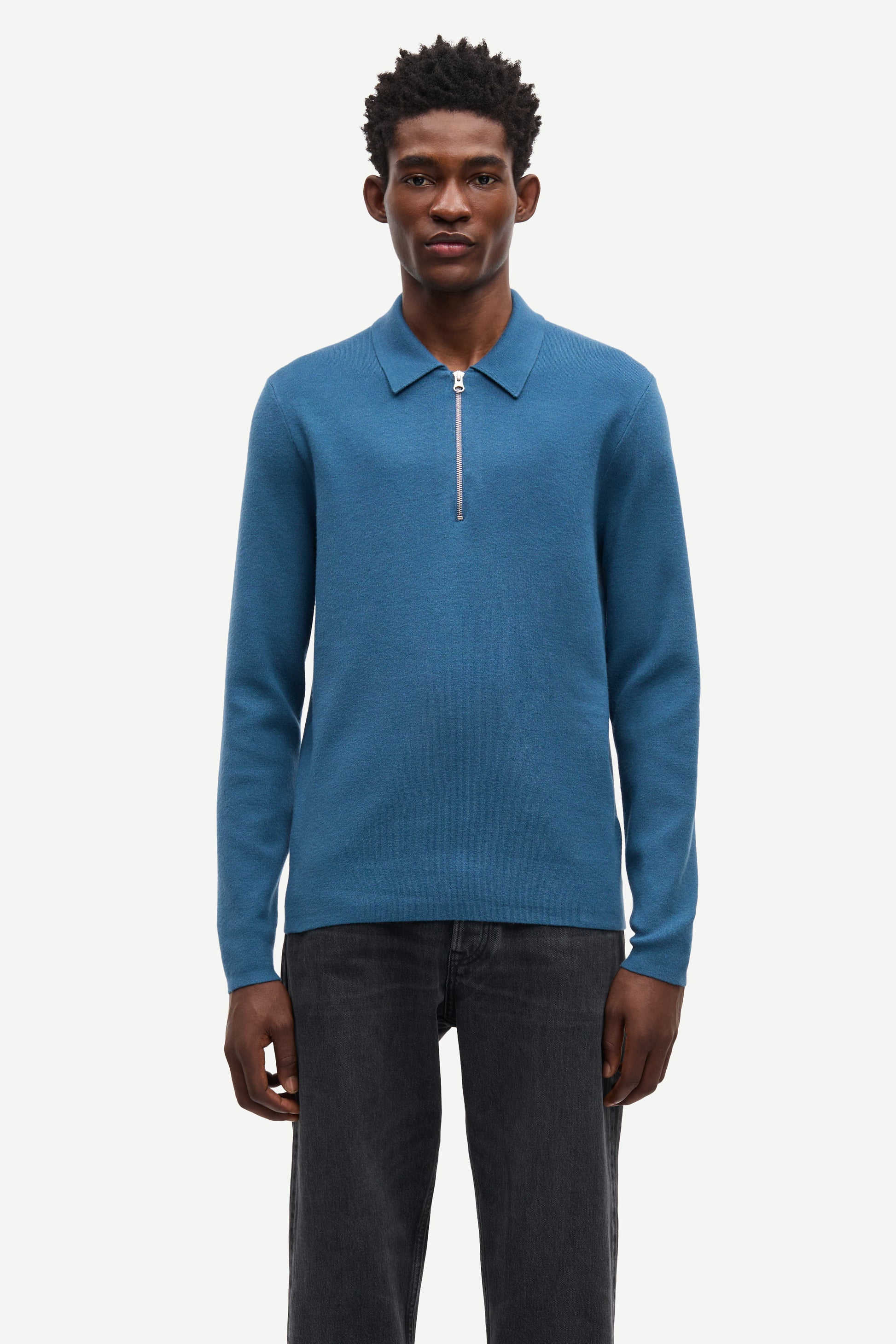 Blue long-sleeve polo shirt with a half zipped placket and relaxed fit model shot
