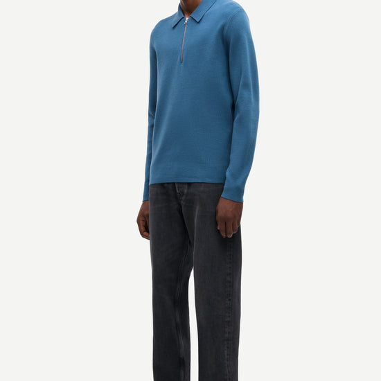 Blue long-sleeve polo shirt with a half zipped placket and relaxed fit side view