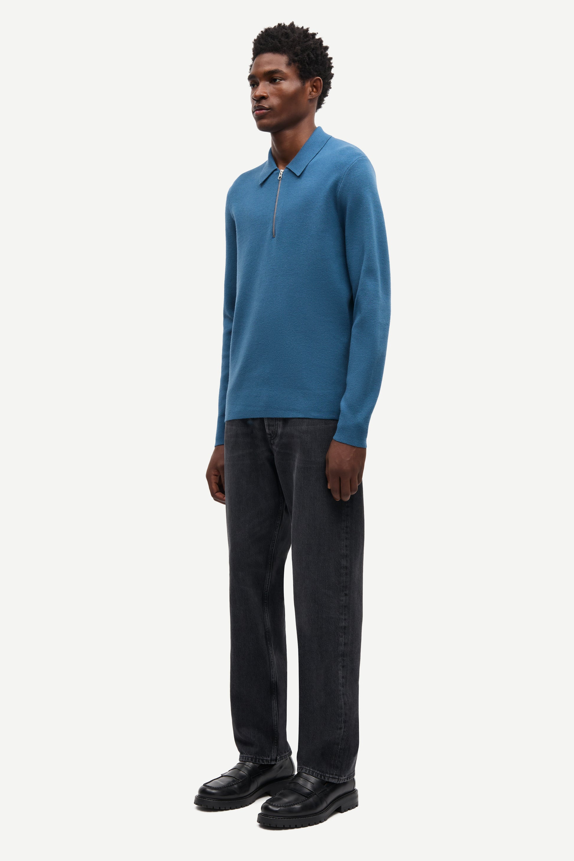 Blue long-sleeve polo shirt with a half zipped placket and relaxed fit side view