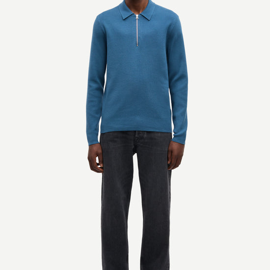 Blue long-sleeve polo shirt with a half zipped placket and relaxed fit model shot