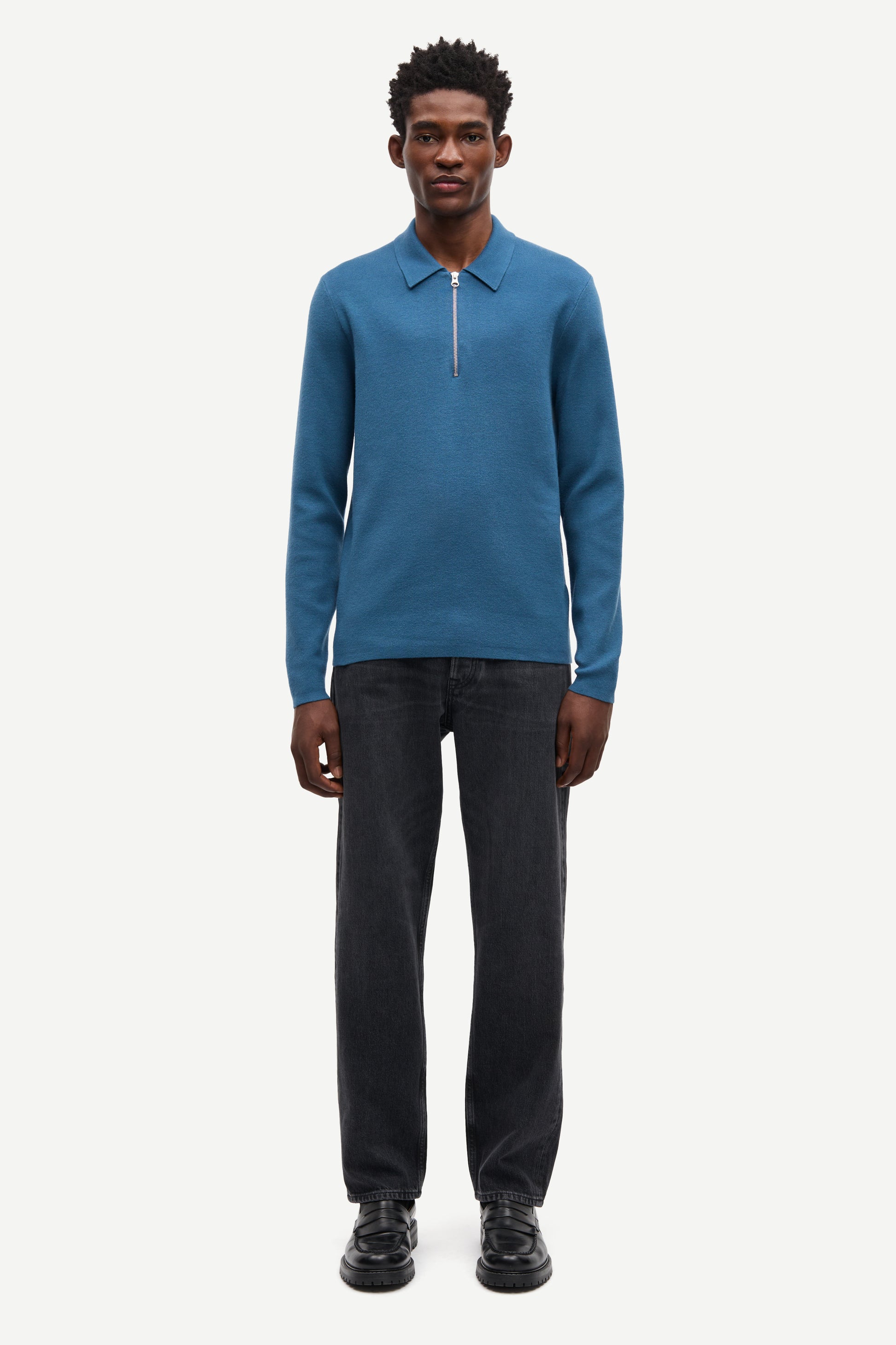 Blue long-sleeve polo shirt with a half zipped placket and relaxed fit model shot