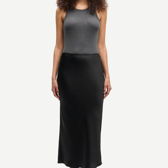 long satin black skirt with elasticated waistband and cut on the bias model shot