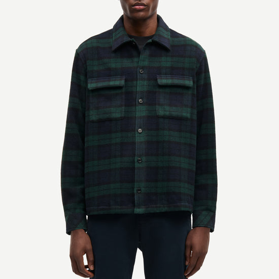 navy and green check overshirt with 2 chest patch pockets and buttoned cuffs from samsoe samsoe model shot