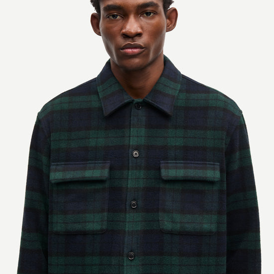 navy and green check overshirt with 2 chest patch pockets and buttoned cuffs from samsoe samsoe model shot