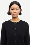 Person wearing a black cardigan on a white background from Samsoe Samsoe