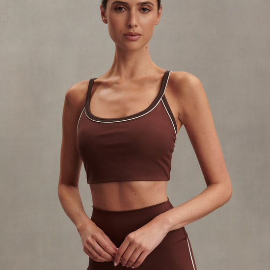 brown sports bra with white piping form varley