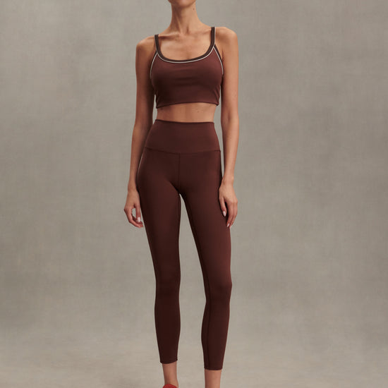 brown sports bra with white piping form varley MODEL SHOT