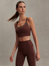brown sports bra with white piping form varley model shot