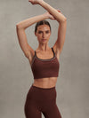 brown sports bra with white piping form varley model shot