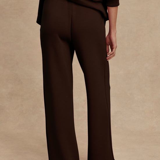 wide leg sweat pants with elasticated waist and piping in the middle down the leg from varley rear view