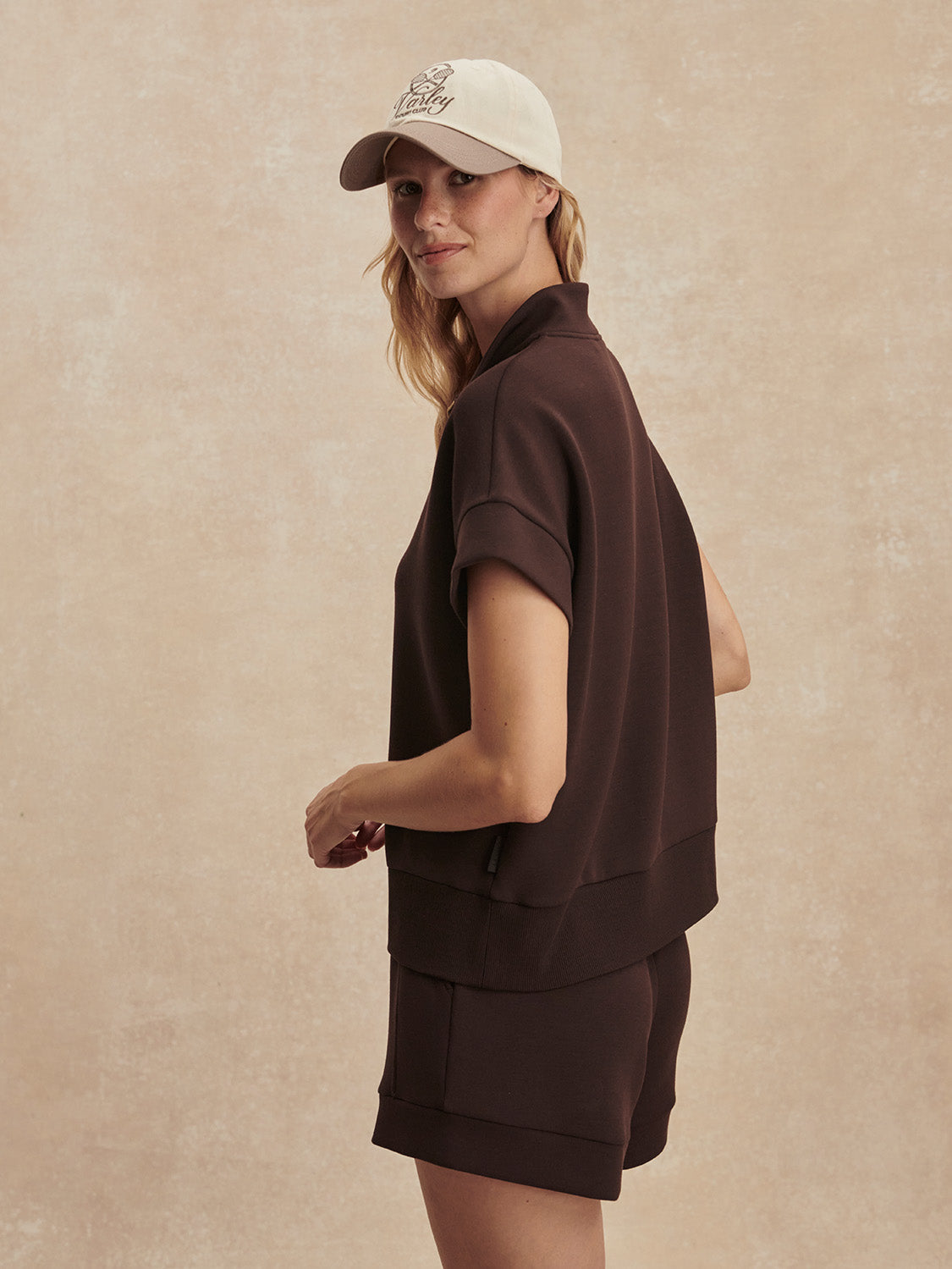 short sleeve chocolate brown sweatshirt with half zip from varley side view