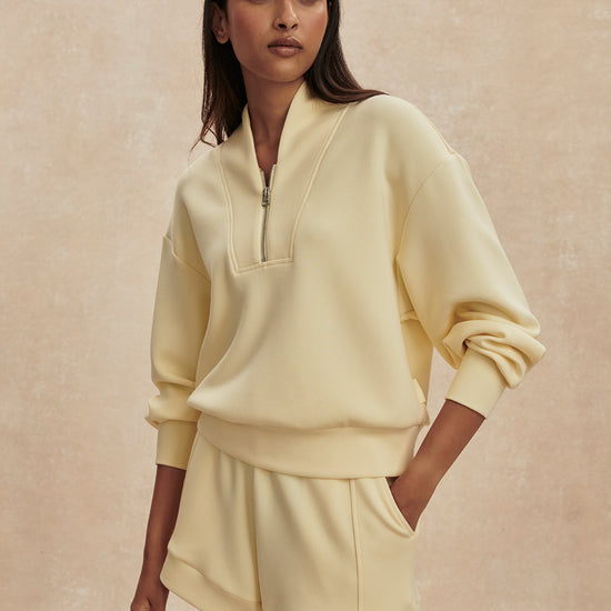 pale yellow jumper with half zip from varley model shot