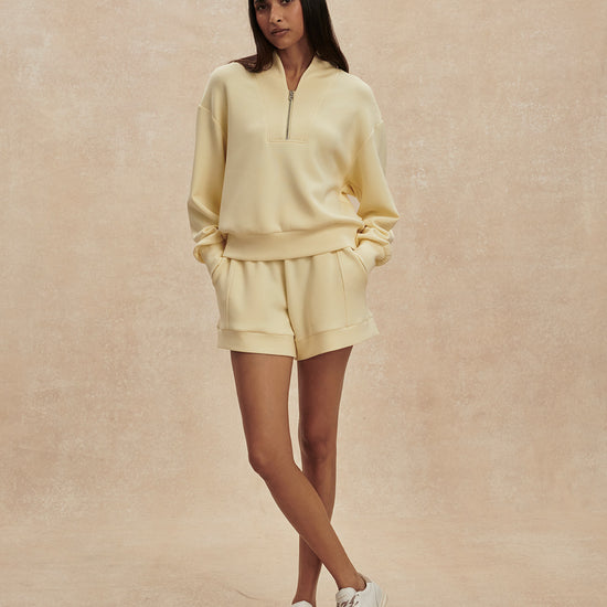 pale yellow jumper with half zip from varley model shot
