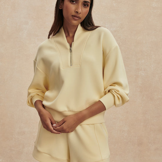 pale yellow jumper with half zip from varley model shot