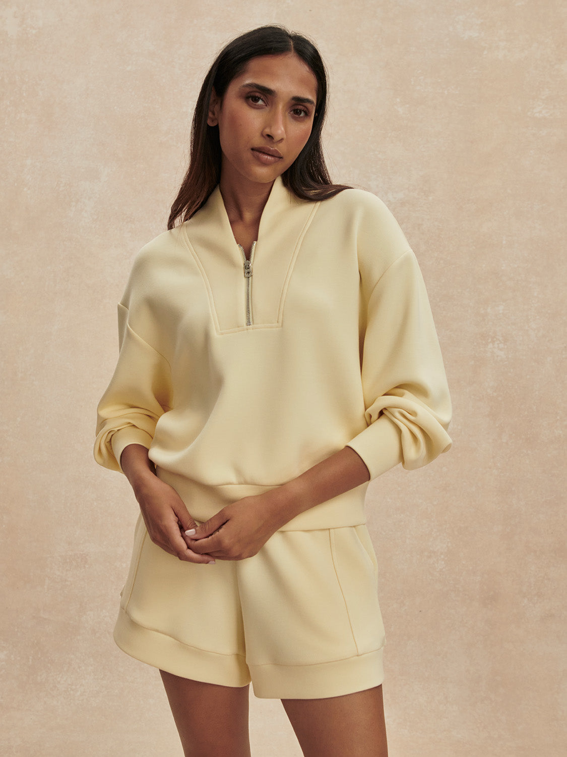 pale yellow jumper with half zip from varley model shot
