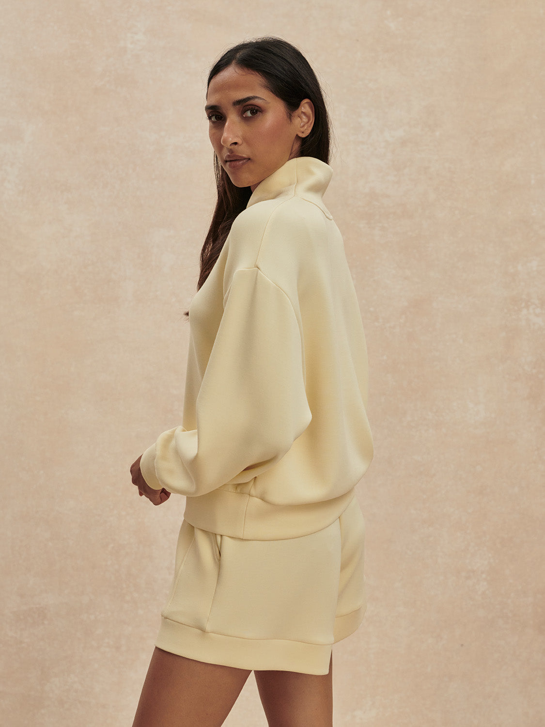 pale yellow jumper with half zip from varley side view