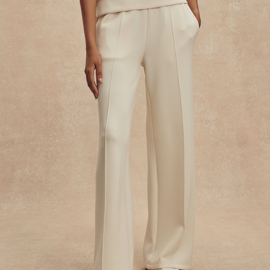 wide leg ivory sweat pants with piping down the centre from varley