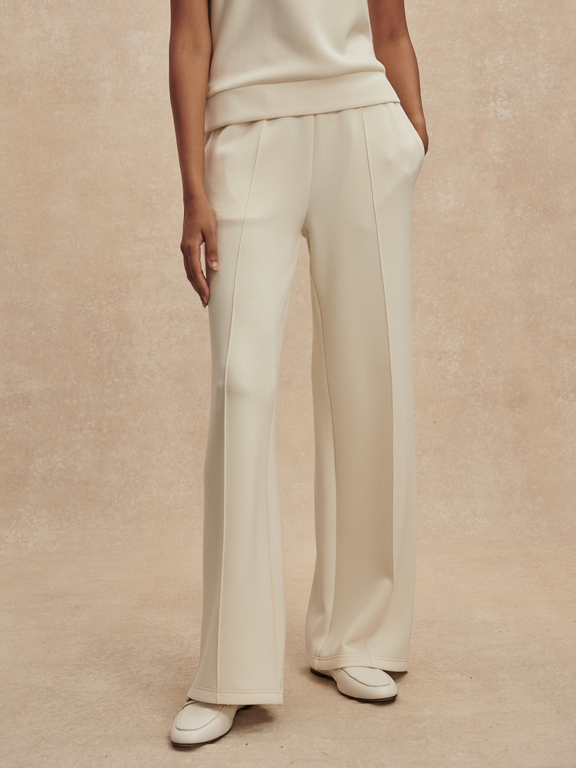 wide leg ivory sweat pants with piping down the centre from varley
