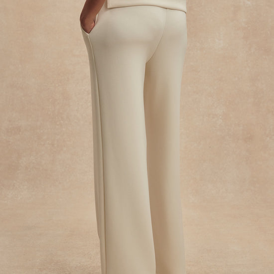 wide leg ivory sweat pants with piping down the centre from varley rear view