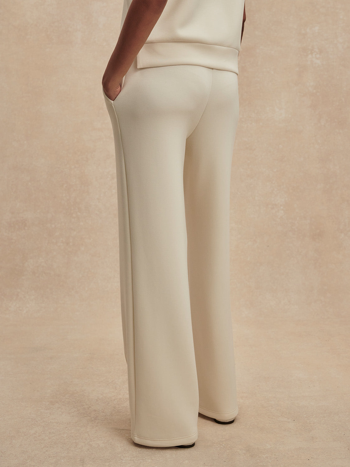 wide leg ivory sweat pants with piping down the centre from varley rear view