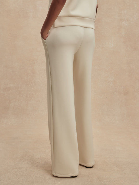 wide leg ivory sweat pants with piping down the centre from varley rear view