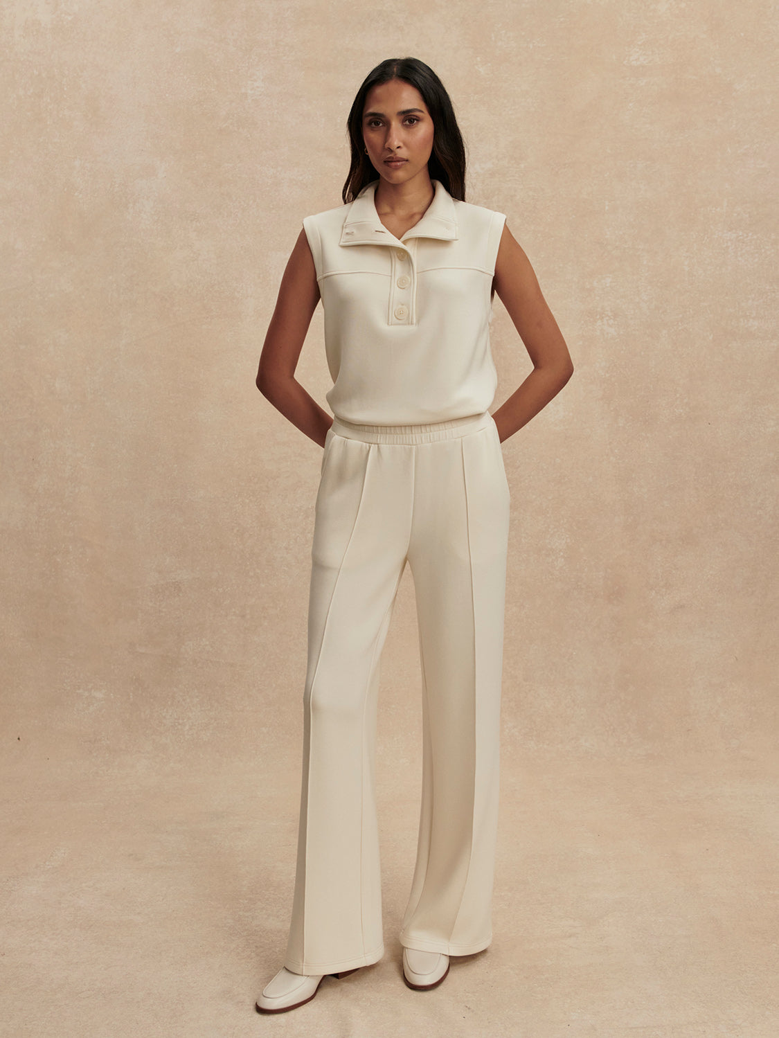 wide leg ivory sweat pants with piping down the centre from varley model shot