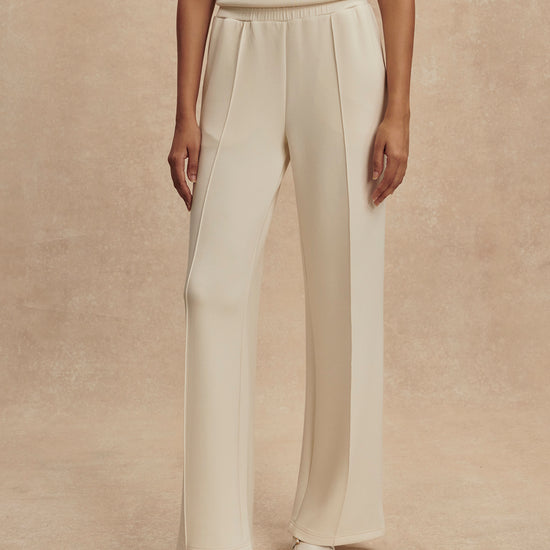 wide leg ivory sweat pants with piping down the centre from varley 