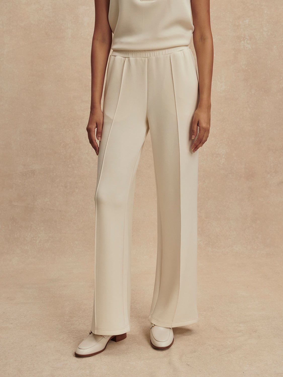 wide leg ivory sweat pants with piping down the centre from varley 