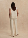 wide leg ivory sweat pants with piping down the centre from varley rear view