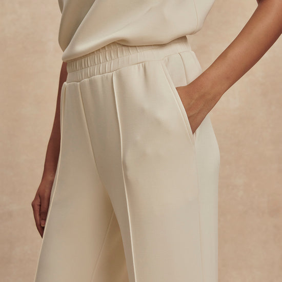 wide leg ivory sweat pants with piping down the centre from varley close up