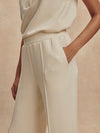 wide leg ivory sweat pants with piping down the centre from varley close up