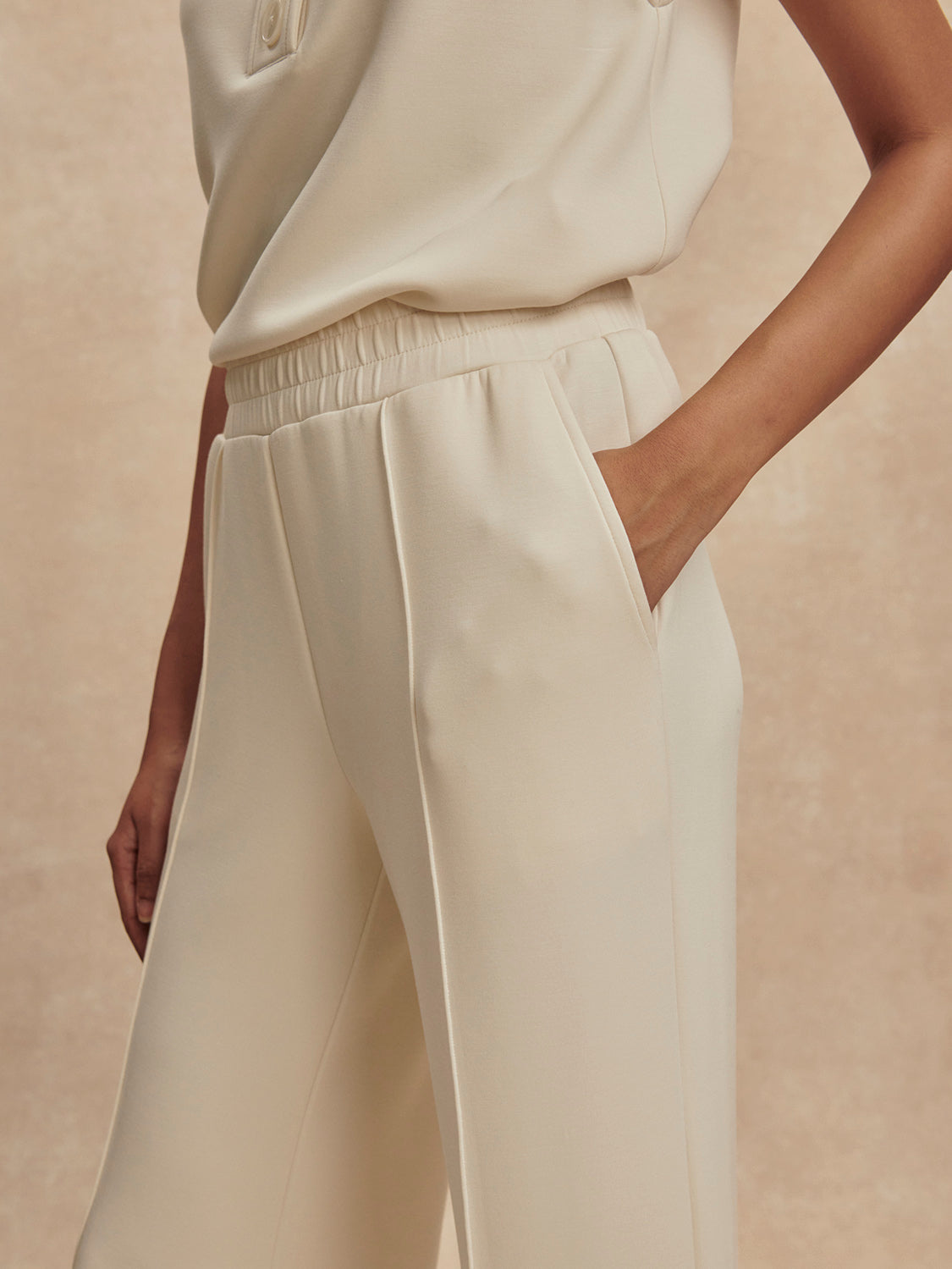 wide leg ivory sweat pants with piping down the centre from varley close up