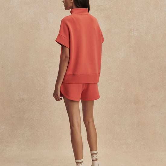 short sleeve coral half zip sweatshirt with high neck from varley rear view
