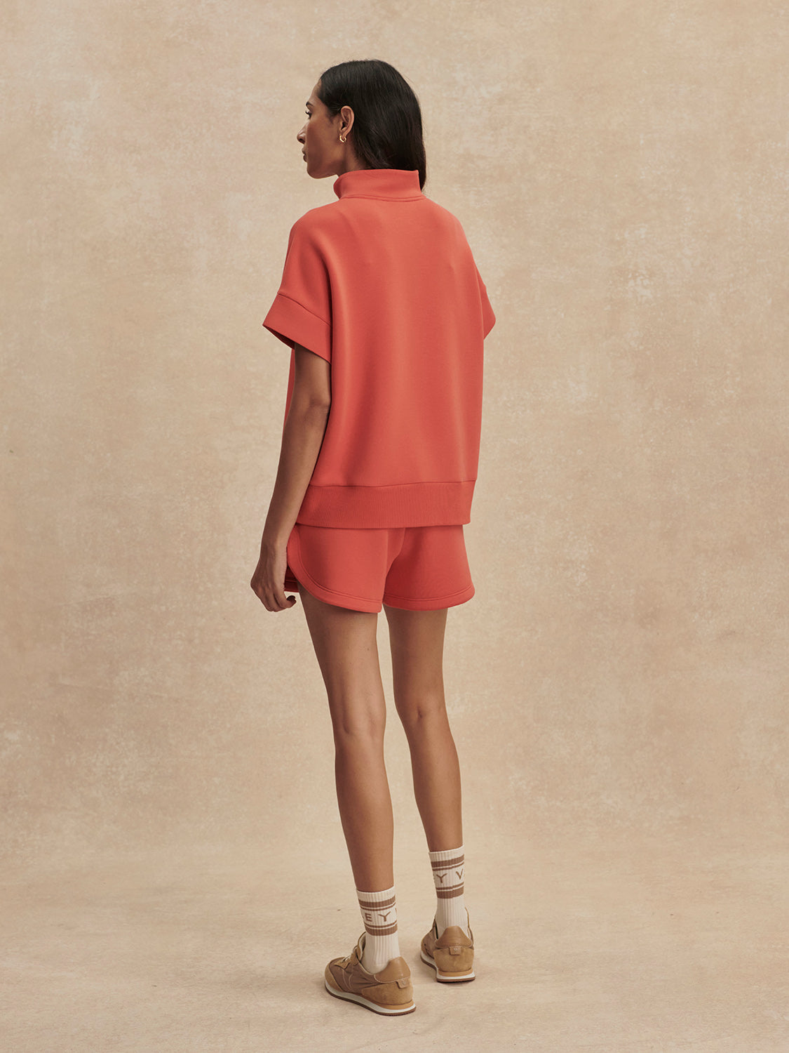 short sleeve coral half zip sweatshirt with high neck from varley rear view