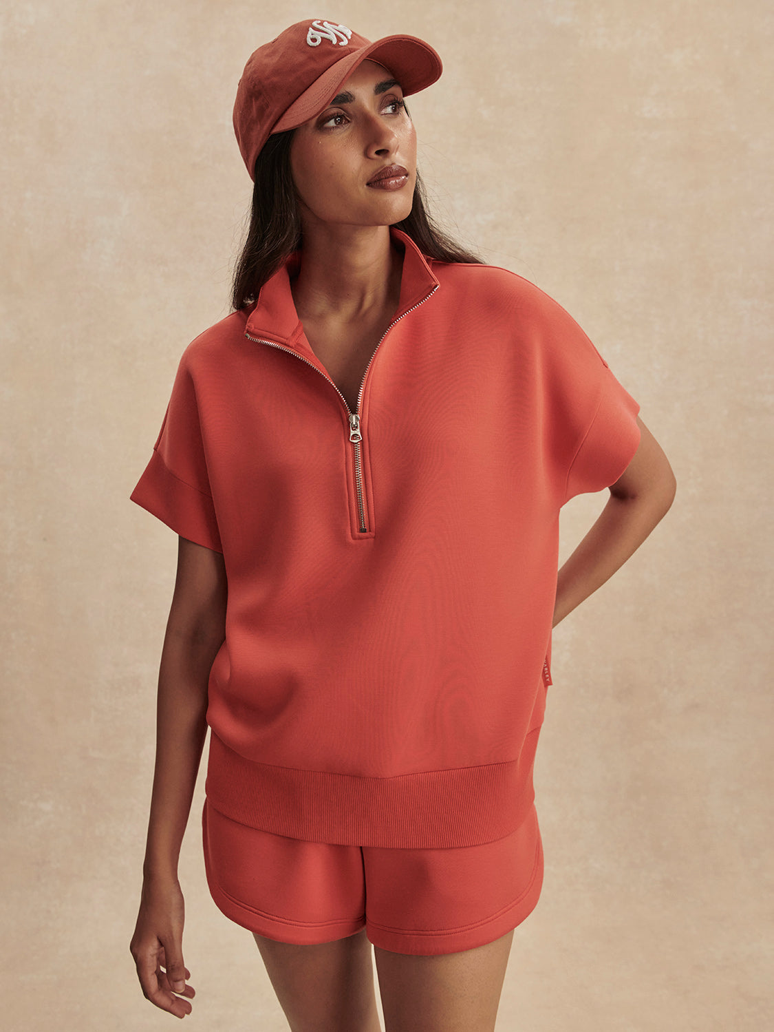 short sleeve coral half zip sweatshirt with high neck from varley model shot