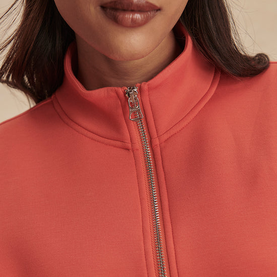 short sleeve coral half zip sweatshirt with high neck from varley close up