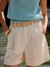 ivory chino style tailored shorts with double buttons and pleat detailing from varley model shot