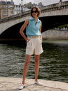 ivory chino style tailored shorts with double buttons and pleat detailing from varley model shot