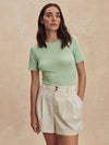 ivory chino style tailored shorts with double buttons and pleat detailing from varley model shot