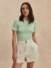 ivory chino style tailored shorts with double buttons and pleat detailing from varley model shot