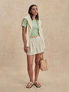 ivory chino style tailored shorts with double buttons and pleat detailing from varley model shot