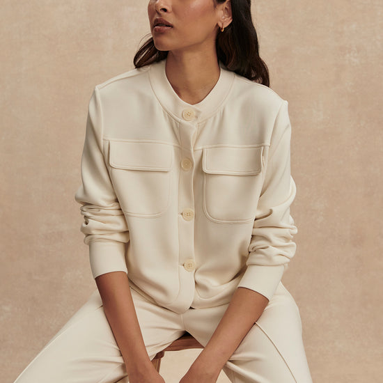 round neck soft sweat jacket with 2 flap pockets and large cream buttons from varley model shot