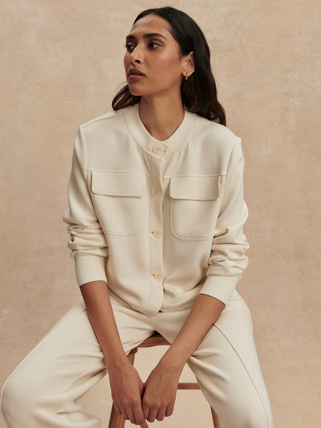 round neck soft sweat jacket with 2 flap pockets and large cream buttons from varley model shot