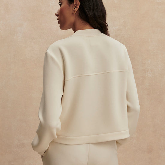 round neck soft sweat jacket with 2 flap pockets and large cream buttons from varley rear view